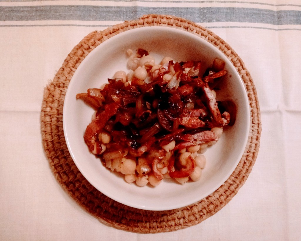 A bowl of pelēkie zirņi ar speķi un ceptiem sīpoliem - grey peas with bacon and fried onions